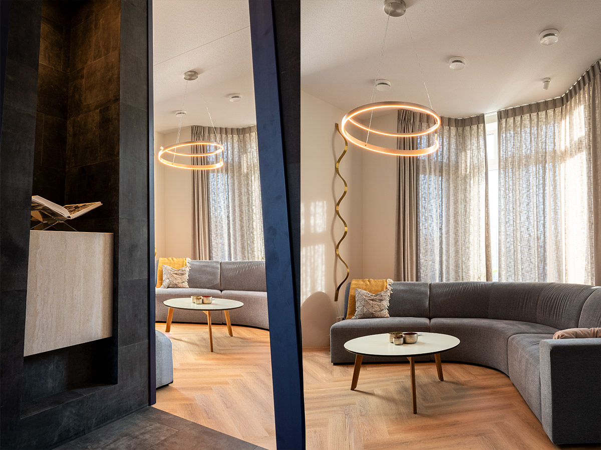 Moderne ringvormige hanglamp boven een zithoek met warm licht, toegepast door Straluma in een stijlvol interieur.