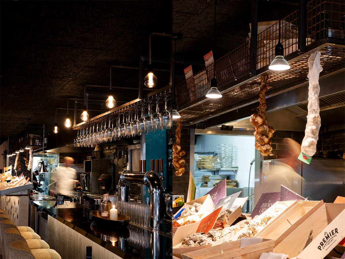 Open keuken en bar van een seafoodrestaurant met industriële hanglampen en sfeervolle verlichting van Straluma